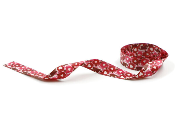 Nastro promozionale rosso e rosa con motivo a cuori. Stampa bifacciale satura, ideale per regali aziendali di San Valentino. Produttore AMGS Group.